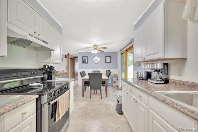 6516 Weyer Rd, Imlay City, MI 48444 - kitchen with electric stove, under cabinet range hood, a ceiling fan, white cabinets, and a textured ceiling
