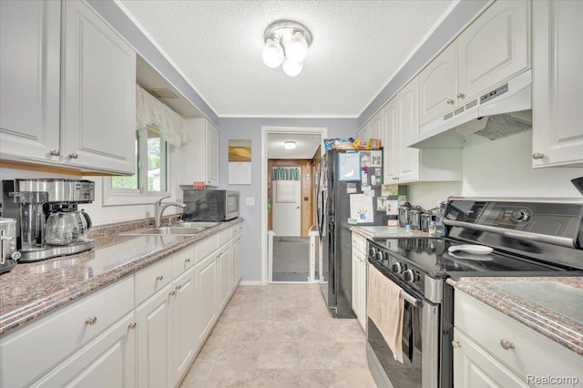 6516 Weyer Rd, Imlay City, MI 48444 - kitchen with stainless steel range with electric cooktop, under cabinet range hood, black microwave, a textured ceiling, and white cabinetry