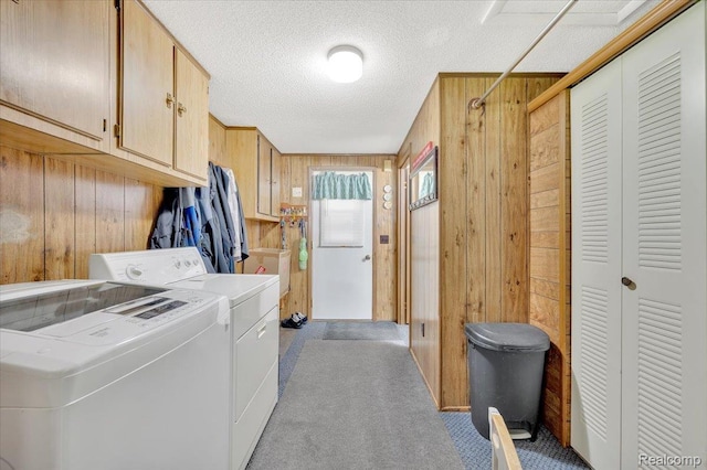 6516 Weyer Rd, Imlay City, MI 48444 - laundry room with wooden walls, cabinet space, washer and clothes dryer, carpet, and a textured ceiling