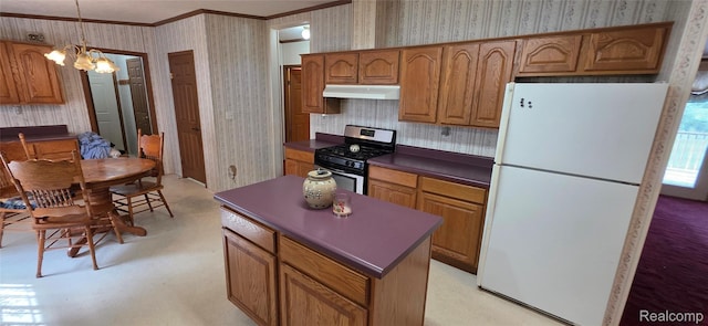19270 W Brant Rd, Brant, MI 48614 - kitchen featuring freestanding refrigerator, stainless steel gas stove, under cabinet range hood, wallpapered walls, and dark countertops