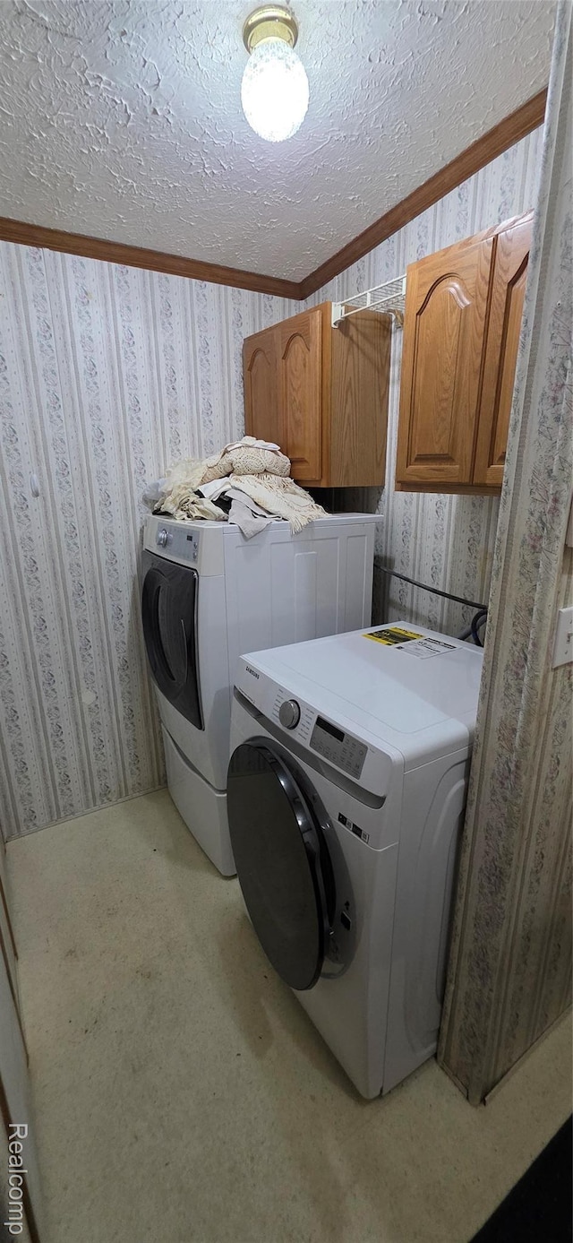 19270 W Brant Rd, Brant, MI 48614 - laundry room featuring cabinet space, washing machine and clothes dryer, wallpapered walls, and a textured ceiling