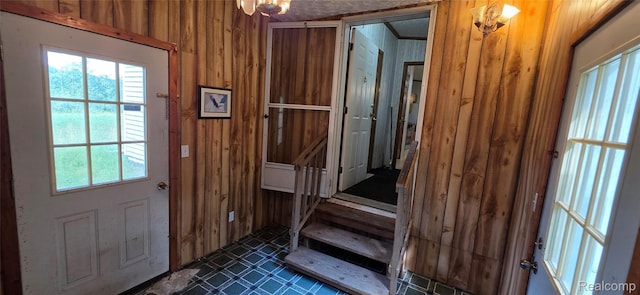 19270 W Brant Rd, Brant, MI 48614 - doorway to outside featuring wood walls, stairway, and dark tile patterned flooring