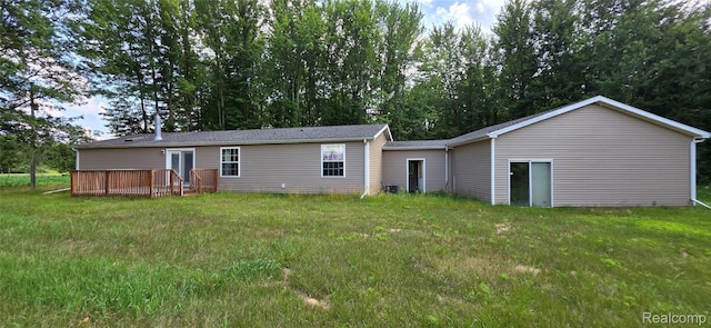 19270 W Brant Rd, Brant, MI 48614 - rear view of house featuring a deck, a lawn, and view of wooded area