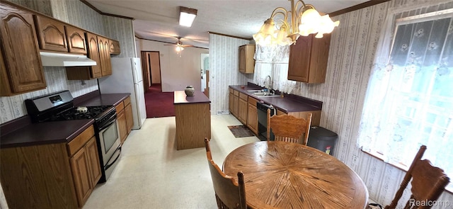 19270 W Brant Rd, Brant, MI 48614 - kitchen featuring gas range, wallpapered walls, under cabinet range hood, dark countertops, and ornamental molding