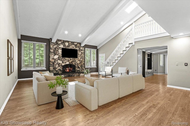 5152 Shenandoah Ct, West Bloomfield, MI 48323 - living area featuring a fireplace, stairs, wood finished floors, and a textured ceiling