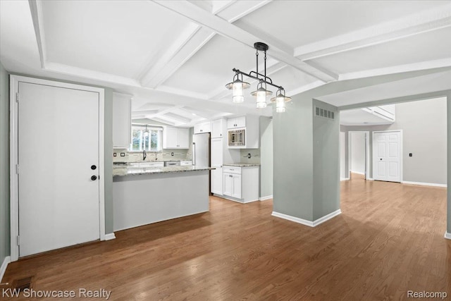 5152 Shenandoah Ct, West Bloomfield, MI 48323 - kitchen with stainless steel appliances, white cabinets, light stone counters, wood finished floors, and a peninsula