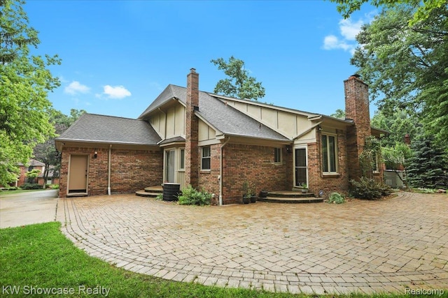 5152 Shenandoah Ct, West Bloomfield, MI 48323 - rear view of house featuring a chimney and brick siding