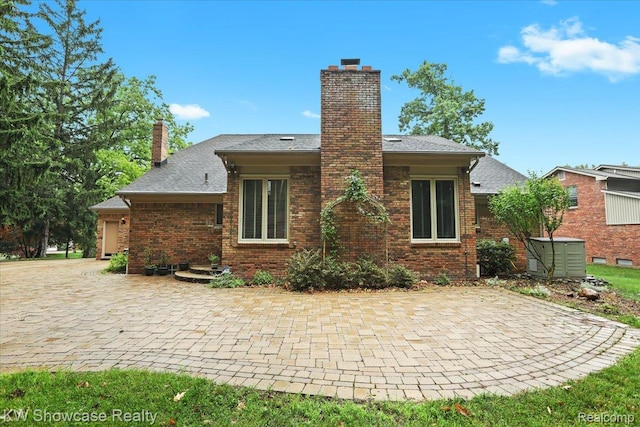 5152 Shenandoah Ct, West Bloomfield, MI 48323 - back of house featuring a chimney and brick siding