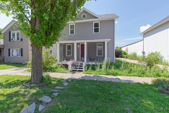 334 Erie St, Adrian, MI 49221 - view of front facade featuring covered porch and a front lawn