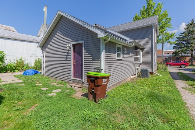 334 Erie St, Adrian, MI 49221 - view of home's exterior with a cooling unit and a lawn