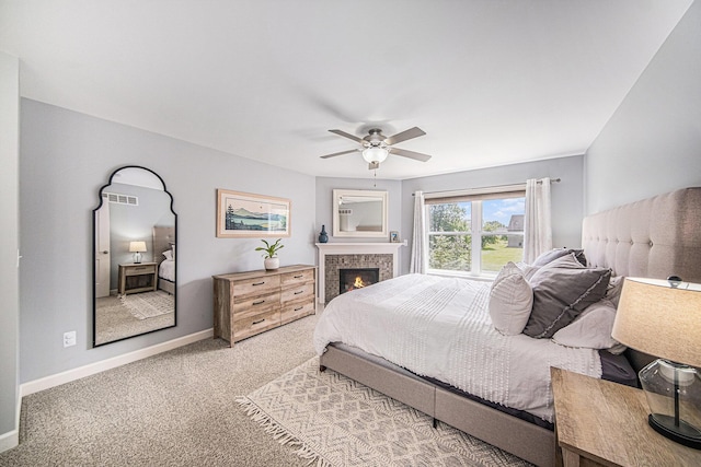 3544 Lexington Cir, Dexter, MI 48130 - carpeted bedroom featuring a ceiling fan and a tiled fireplace