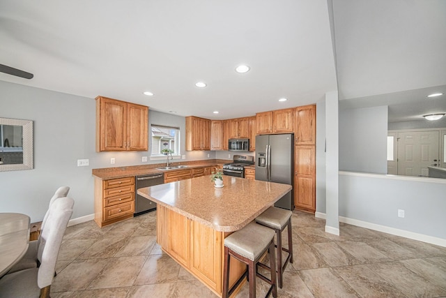 3544 Lexington Cir, Dexter, MI 48130 - kitchen with appliances with stainless steel finishes, a kitchen island, a breakfast bar, recessed lighting, and light stone counters