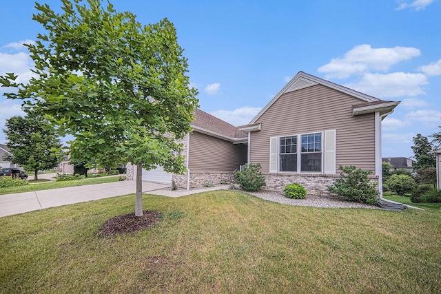 3544 Lexington Cir, Dexter, MI 48130 - view of front of property with driveway, a garage, a front lawn, and stone siding
