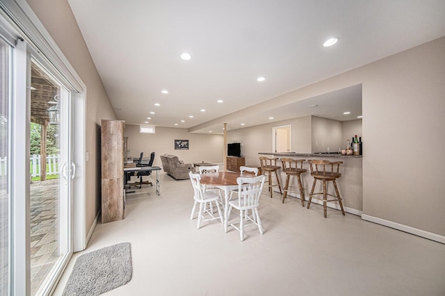 3544 Lexington Cir, Dexter, MI 48130 - dining area featuring bar area, recessed lighting, and finished concrete floors
