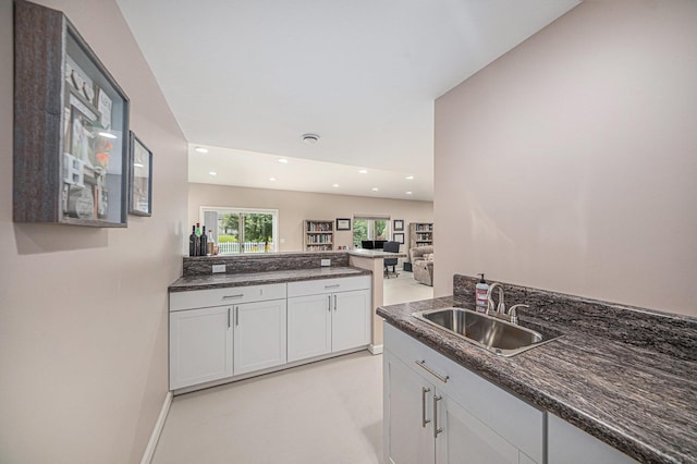 3544 Lexington Cir, Dexter, MI 48130 - kitchen featuring recessed lighting, a peninsula, white cabinetry, dark stone countertops, and open floor plan
