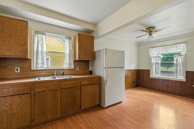 2251 Gardner Ave, Berkley, MI 48072 - kitchen featuring freestanding refrigerator, a wainscoted wall, light wood-style floors, brown cabinets, and light countertops