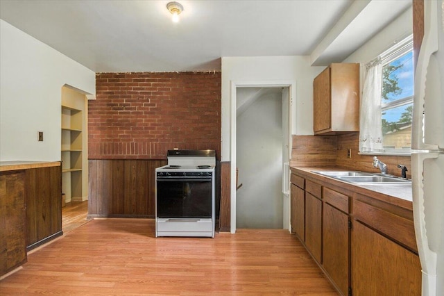 2251 Gardner Ave, Berkley, MI 48072 - kitchen featuring white range with electric cooktop, light wood finished floors, and brown cabinetry