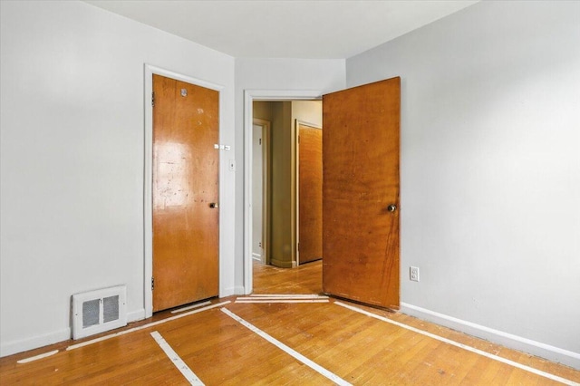 2251 Gardner Ave, Berkley, MI 48072 - unfurnished bedroom with wood finished floors and baseboards
