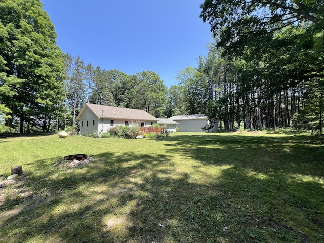 2564 Bialik Rd, Manistee, MI 49660 - view of green lawn with view of wooded area