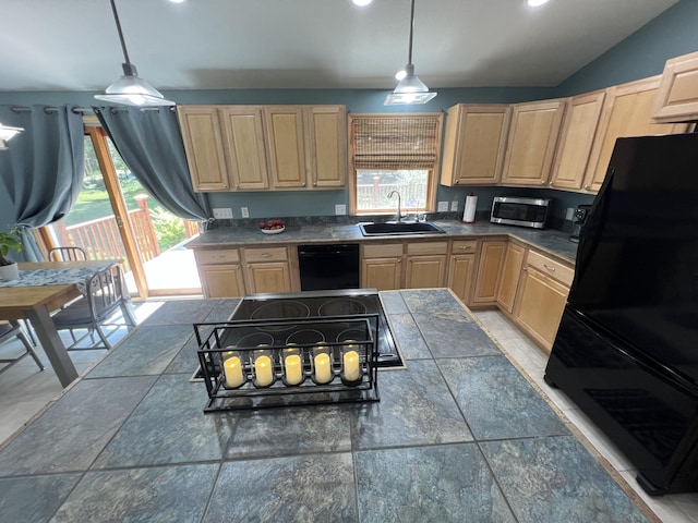 2564 Bialik Rd, Manistee, MI 49660 - kitchen with light brown cabinets, black appliances, dark countertops, hanging light fixtures, and lofted ceiling