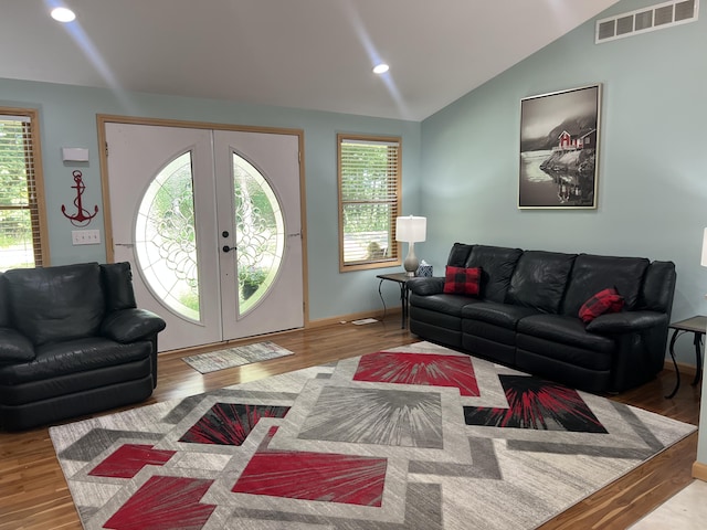 2564 Bialik Rd, Manistee, MI 49660 - living area featuring wood finished floors, lofted ceiling, french doors, and recessed lighting
