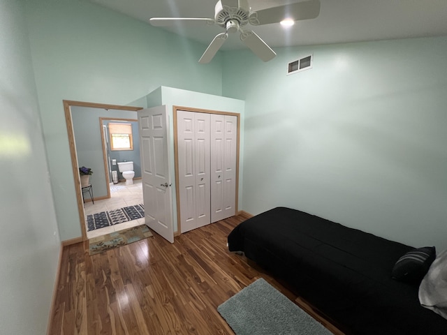 2564 Bialik Rd, Manistee, MI 49660 - bedroom with high vaulted ceiling, wood finished floors, a closet, and a ceiling fan