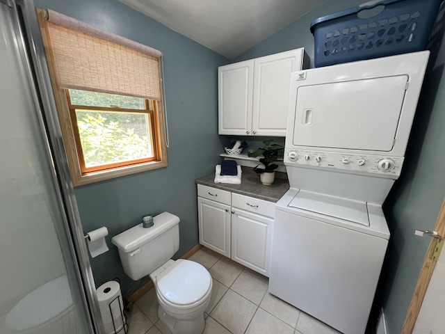 2564 Bialik Rd, Manistee, MI 49660 - bathroom featuring stacked washer / drying machine, vaulted ceiling, tile patterned flooring, and a shower
