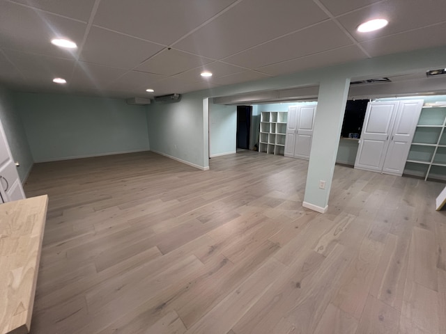 2564 Bialik Rd, Manistee, MI 49660 - finished below grade area with light wood-style floors, a paneled ceiling, and recessed lighting