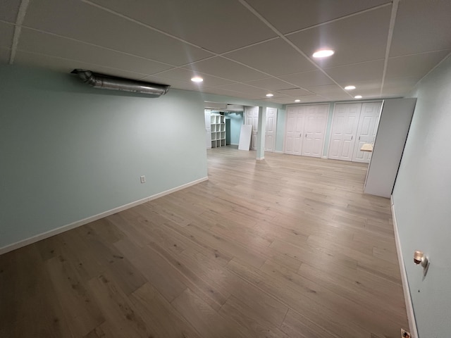 2564 Bialik Rd, Manistee, MI 49660 - finished below grade area featuring recessed lighting, light wood-style flooring, and a paneled ceiling
