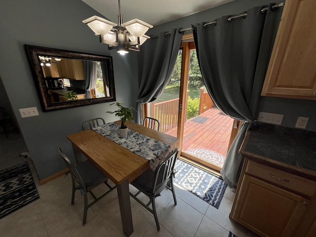 2564 Bialik Rd, Manistee, MI 49660 - tiled dining area with a chandelier and vaulted ceiling