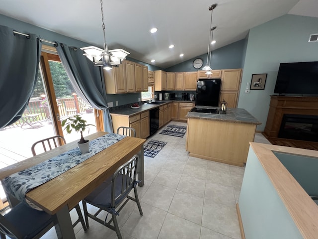 2564 Bialik Rd, Manistee, MI 49660 - kitchen featuring black appliances, light brown cabinetry, lofted ceiling, a kitchen island, and dark countertops