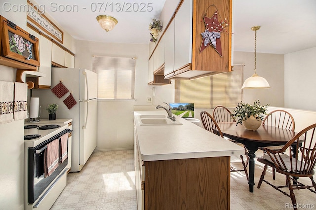 123 N Hawthorne St, Westland, MI 48185 - kitchen with white electric stove, light floors, light countertops, and decorative light fixtures