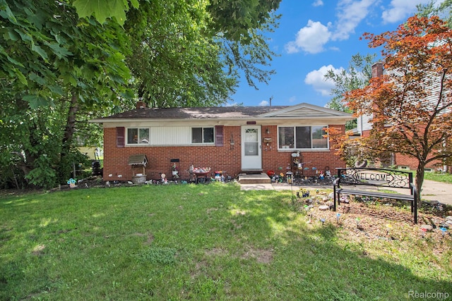 34919 Glover, Wayne, MI 48184 - view of front of property featuring brick siding, a front yard, a chimney, and entry steps