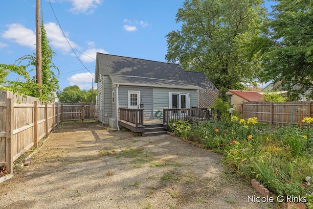 911 Baldwin St SE, Grand Rapids, MI 49506 - back of house featuring a wooden deck, a fenced backyard, and a shingled roof