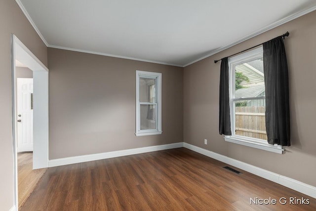 911 Baldwin St SE, Grand Rapids, MI 49506 - spare room featuring wood finished floors and ornamental molding