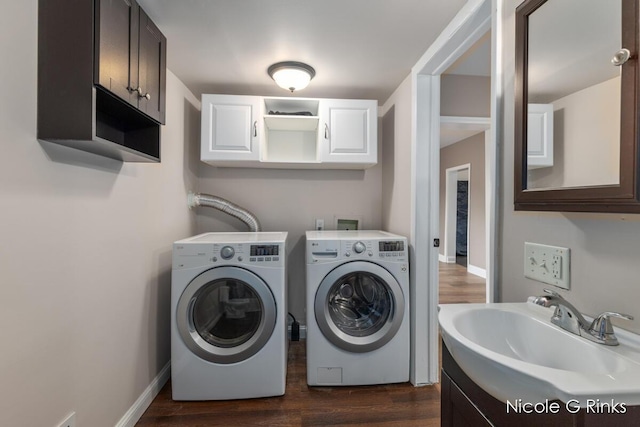911 Baldwin St SE, Grand Rapids, MI 49506 - washroom featuring washing machine and clothes dryer, cabinet space, and dark wood finished floors