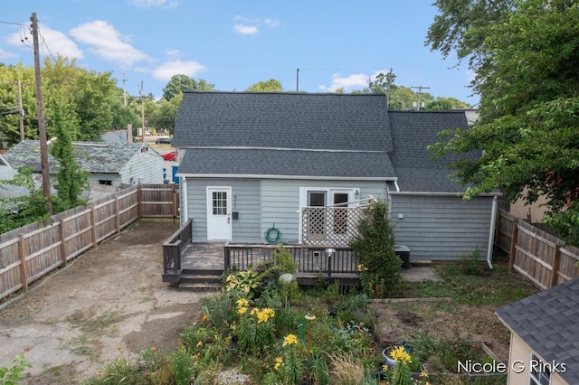911 Baldwin St SE, Grand Rapids, MI 49506 - back of house featuring a shingled roof, a deck, and a fenced backyard