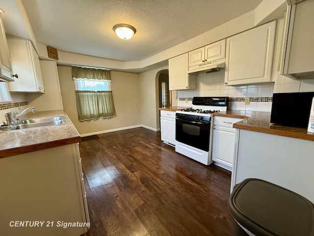 3525 Shattuck Rd, Saginaw, MI 48603 - kitchen with gas stove, arched walkways, tasteful backsplash, a textured ceiling, and white cabinetry