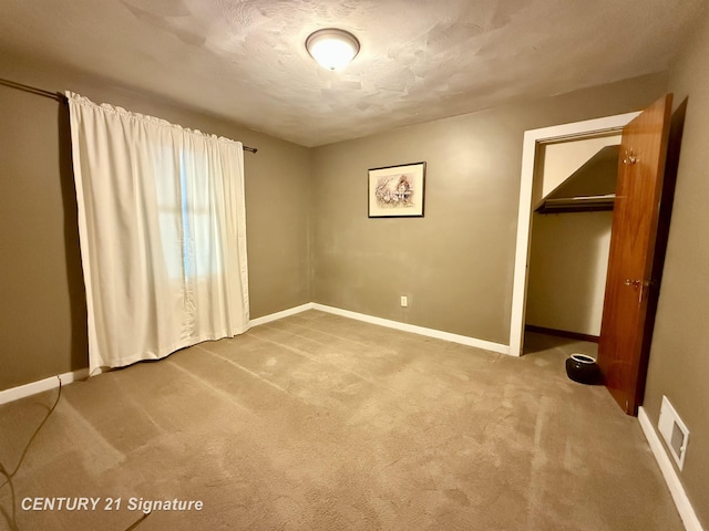 3525 Shattuck Rd, Saginaw, MI 48603 - unfurnished bedroom with carpet flooring, a closet, and a textured ceiling
