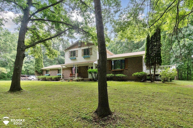 11206 E Atherton Rd, Davison, MI 48423 - view of front facade featuring a front yard, brick siding, and covered porch