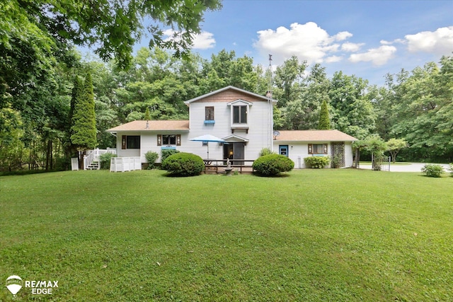 11206 E Atherton Rd, Davison, MI 48423 - back of property with a yard, view of wooded area, and a chimney