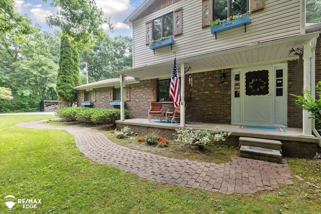 11206 E Atherton Rd, Davison, MI 48423 - property entrance with a porch, brick siding, and a lawn