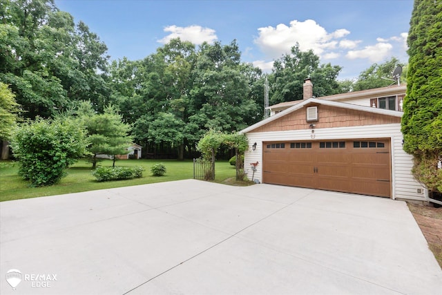 11206 E Atherton Rd, Davison, MI 48423 - view of side of home with a lawn, driveway, and a chimney