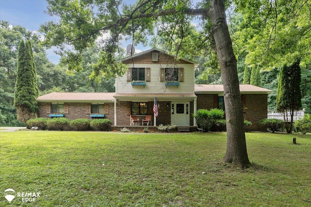 11206 E Atherton Rd, Davison, MI 48423 - view of front of home featuring a porch, a front yard, and brick siding