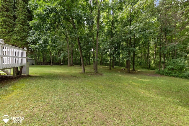 11206 E Atherton Rd, Davison, MI 48423 - view of grassy yard featuring a wooden deck and a forest view