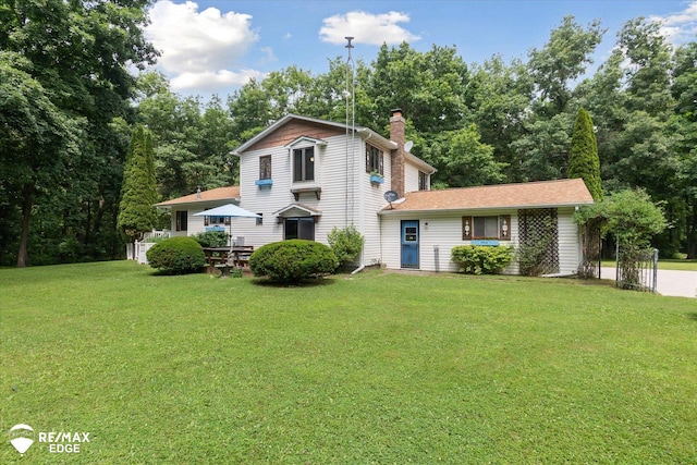 11206 E Atherton Rd, Davison, MI 48423 - traditional-style house featuring a front lawn and a chimney