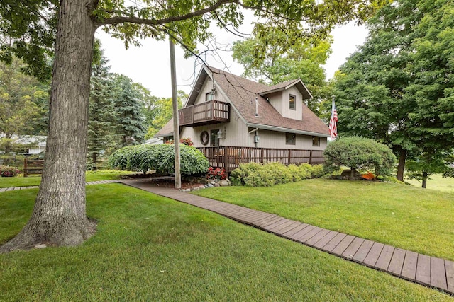 5370 N Lake Sanford Rd, Sanford, MI 48657 - view of side of home featuring a balcony, a yard, and roof with shingles