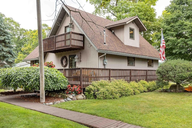 5370 N Lake Sanford Rd, Sanford, MI 48657 - view of front of house with a balcony, roof with shingles, and a front yard