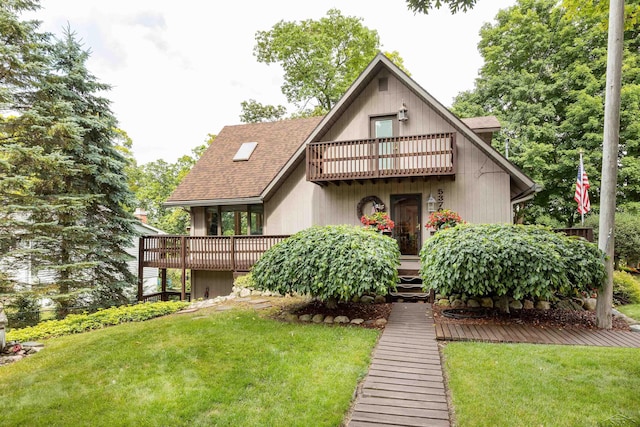 5370 N Lake Sanford Rd, Sanford, MI 48657 - view of front of home with a balcony, a front lawn, and roof with shingles