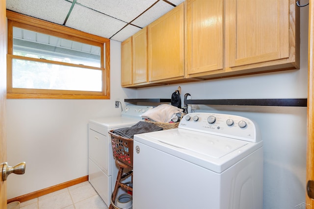 5370 N Lake Sanford Rd, Sanford, MI 48657 - washroom featuring cabinet space, washing machine and dryer, and light tile patterned floors